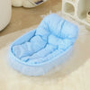Blue pastel pet nest with a padded base, raised sides and decorative lace trim.