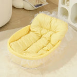 Yellow pastel pet nest with a padded base, raised sides and decorative lace trim.